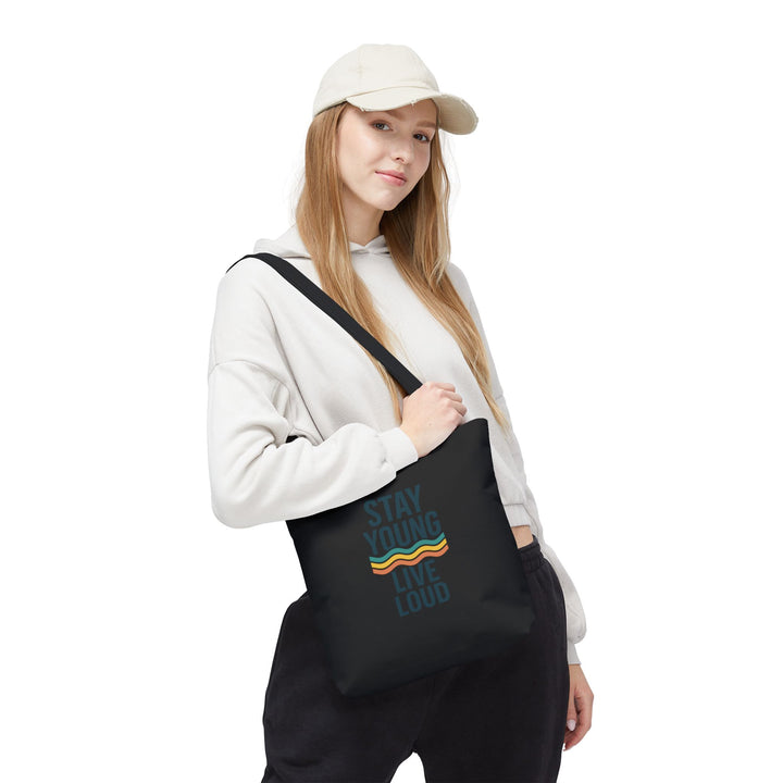 Stay Young, Live Loud Tote Bag-Carry confidence everywhere. This bold tote features Forever Young’s signature slogan and a retro wave design — built to move with you from errands to adventures.