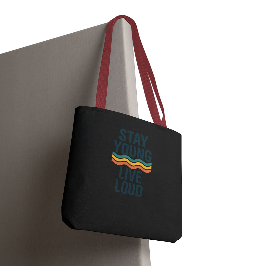 Stay Young, Live Loud Tote Bag-Carry confidence everywhere. This bold tote features Forever Young’s signature slogan and a retro wave design — built to move with you from errands to adventures.